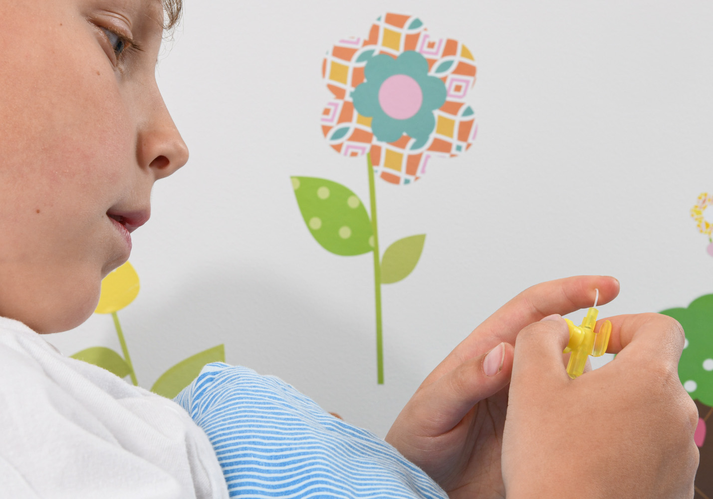 Frank examines the yellow thing and touches the little tube attached to it.