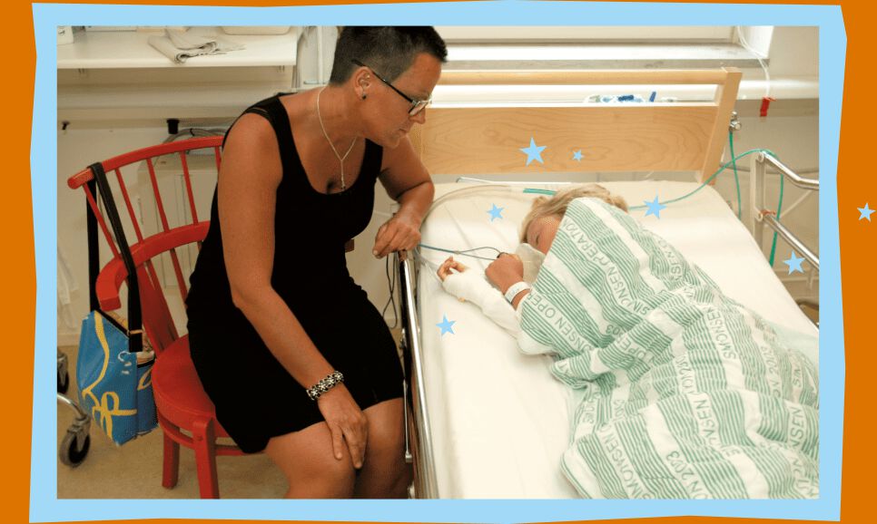 Mom sits on a chair next to Lucas in the recovery ward. Lucas is asleep in his bed.