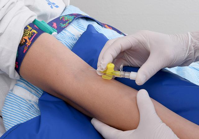 An injection is given to a person in the crook of the arm.